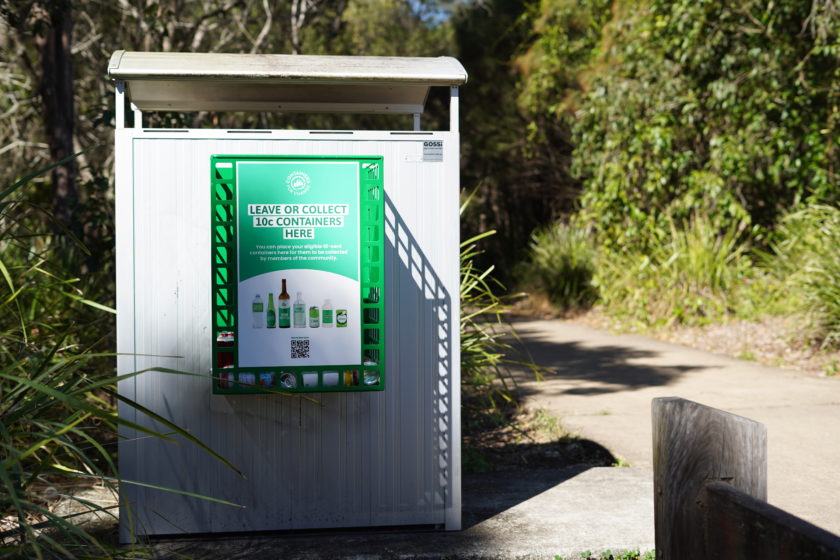 A green Container Exchange Point basket attached to a public bin.