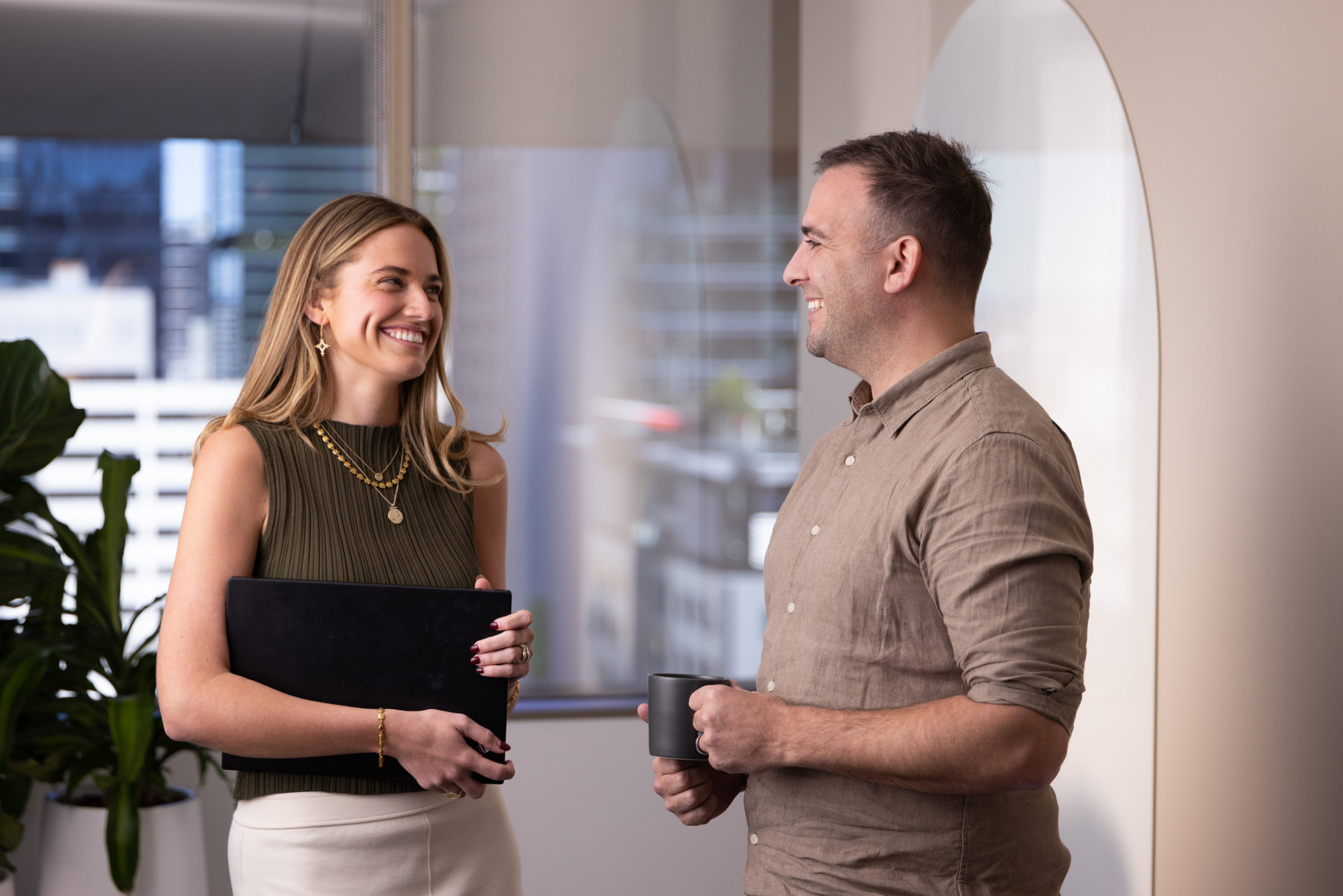 A woman and a man having a conversation in an office.