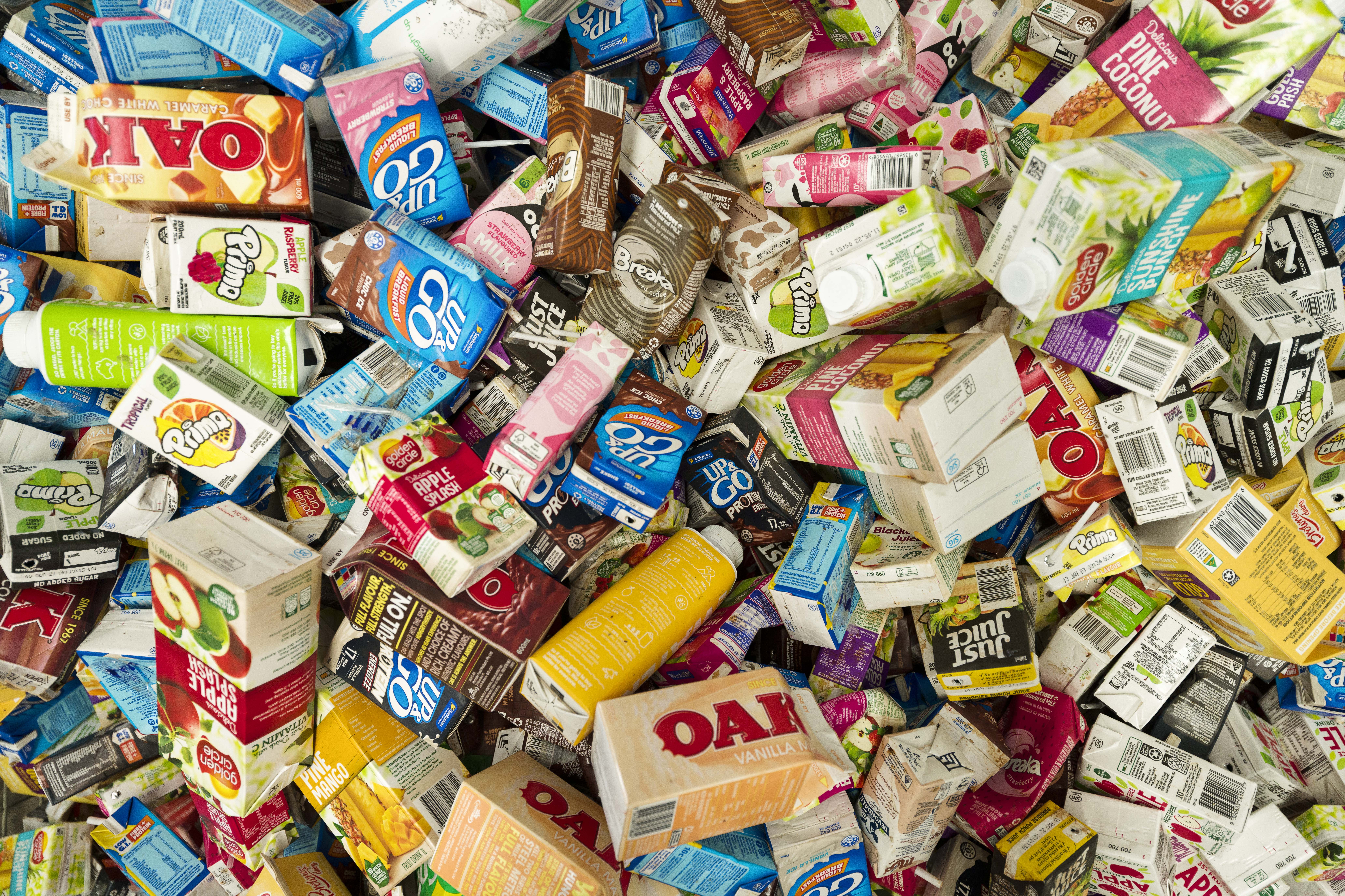 Collection of empty beverage cartons and drink containers prepared for recycling.