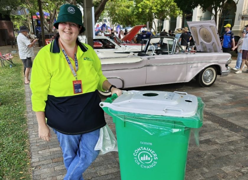 Container Refund Rockhampton General Manager Angela West standing beside a green Containers for Change bin at Rockynats 2026.