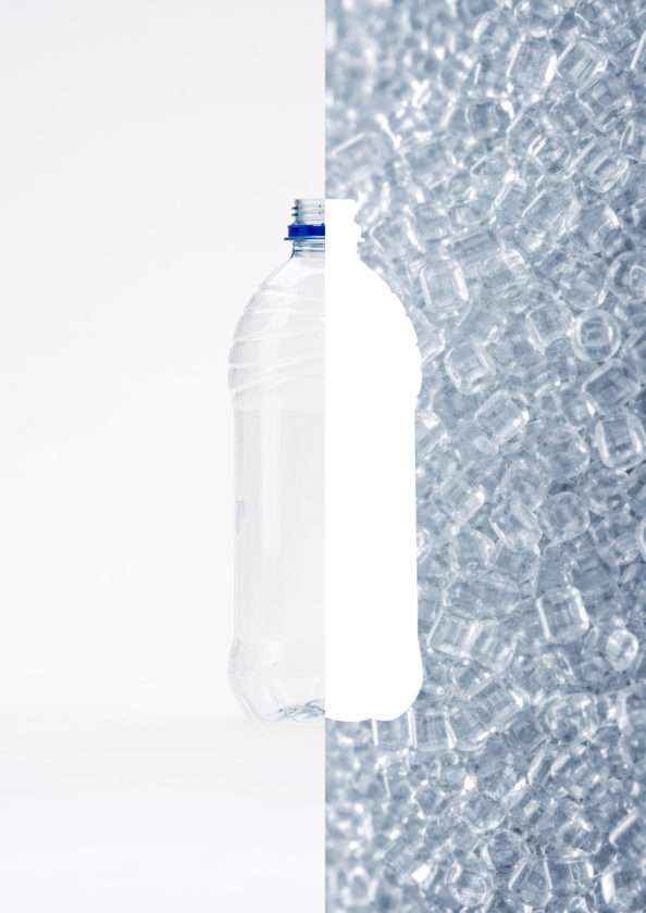 Plastic drink bottle alongside recycled PET plastic pellets, illustrating the PET recycling process.