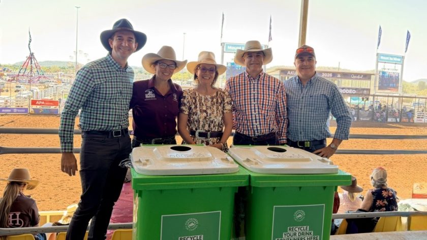 Robbie Katter, Container Exchange CEO Trevor Evans and charity group collectors standing behind Containers for Change recycling bins at an event.